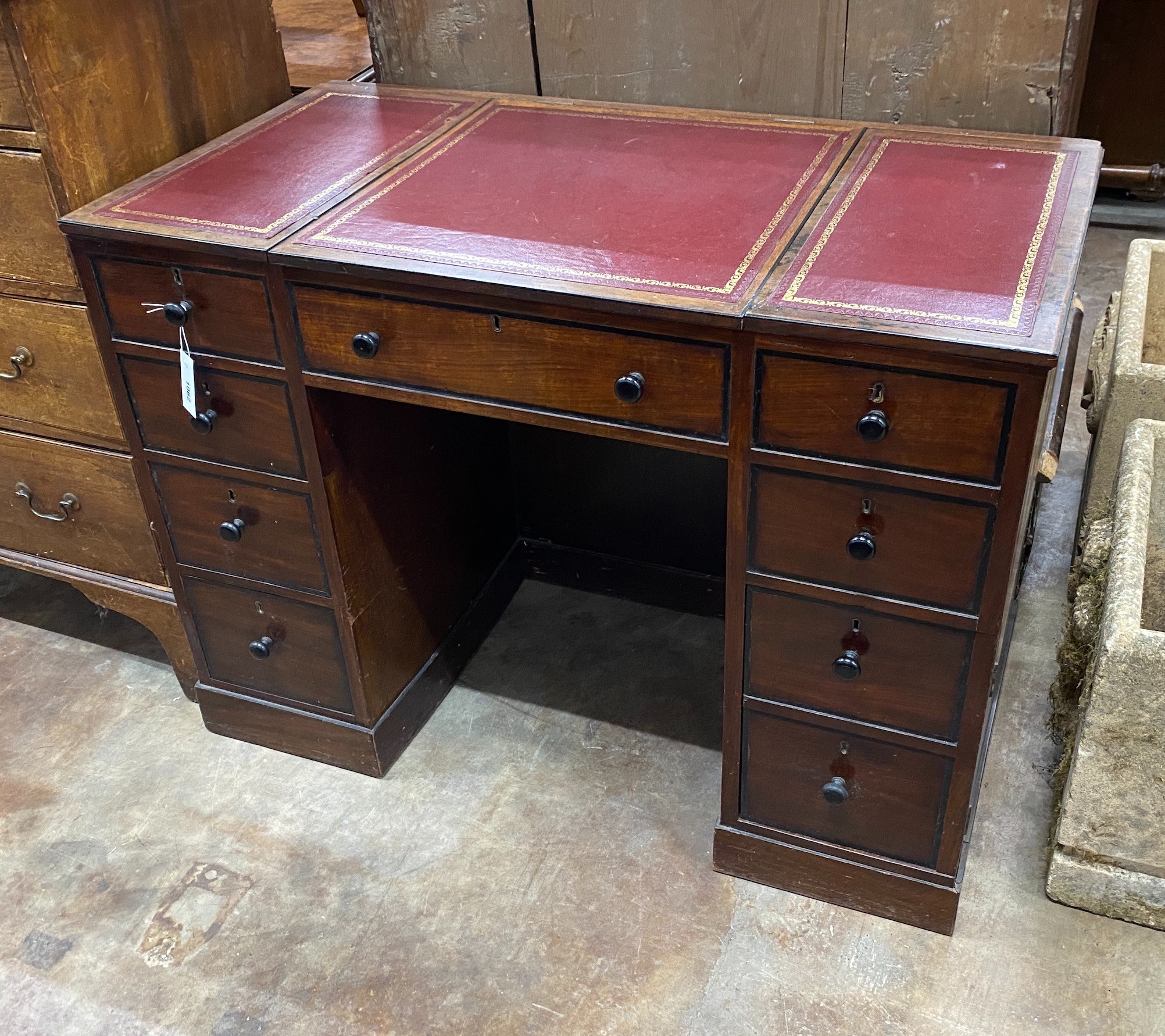 A George III style mahogany kneehole desk with hinged central section, width 104cm, depth 55cm, height 76cm